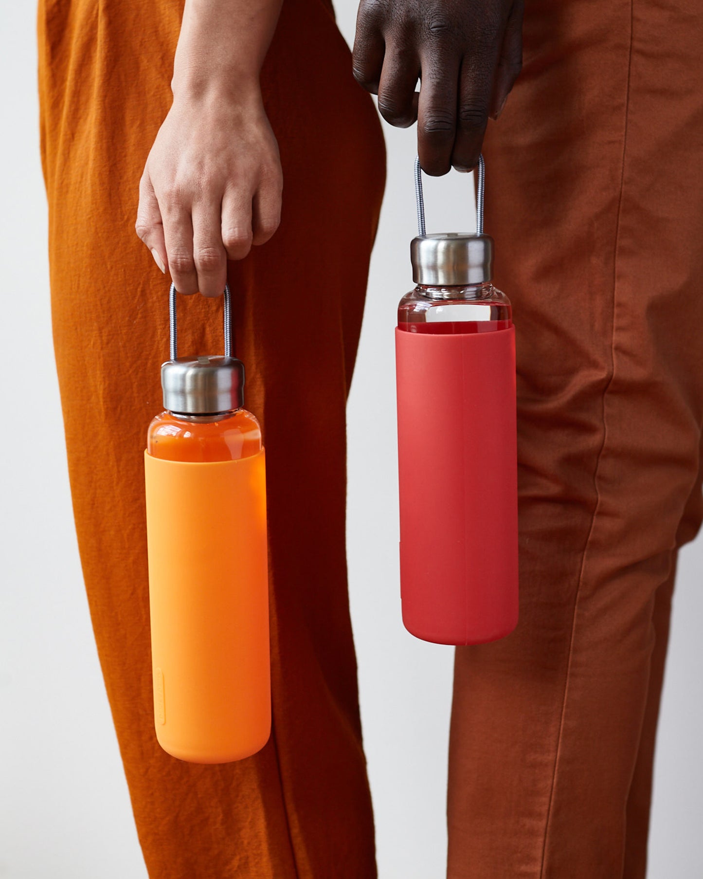 Black+Blum red and orange glass water bottles leak proof